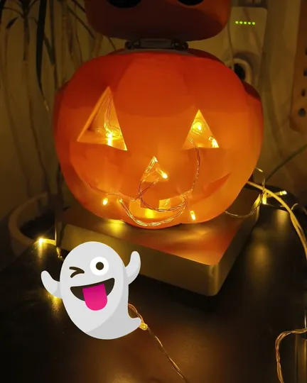 Reachy Mini dressed up as a Halloween pumpkin, shared by Beep Happens